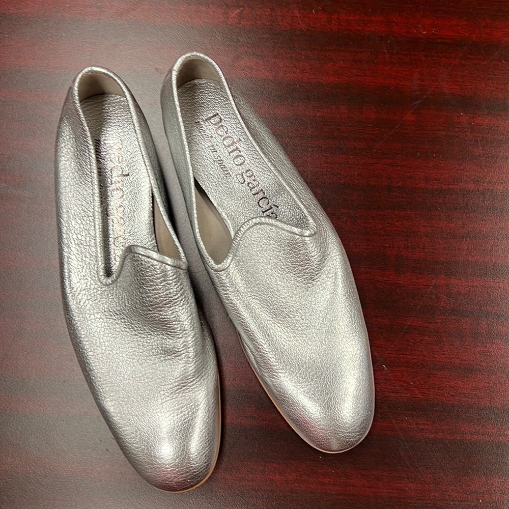 Silver leather slip on sandals.
